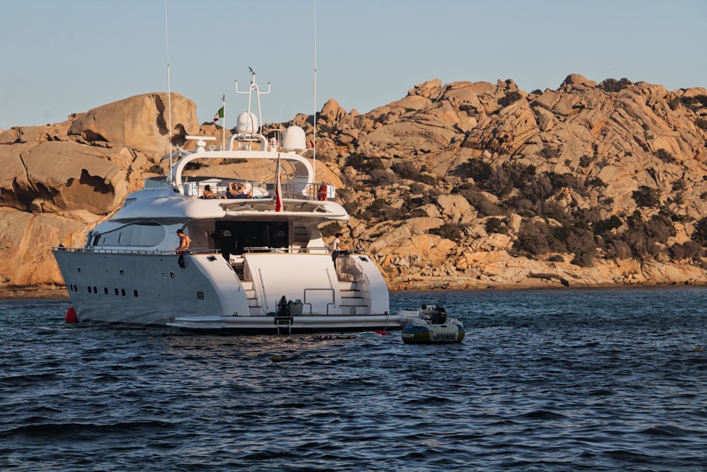 white yacht on body of water during daytime