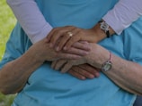 person wearing silver round analog watch