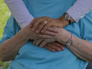 person wearing silver round analog watch