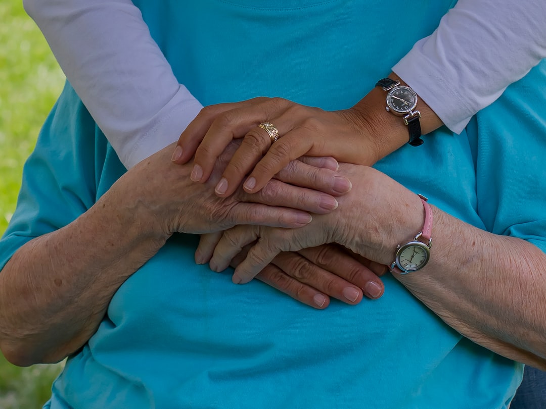 person wearing silver round analog watch