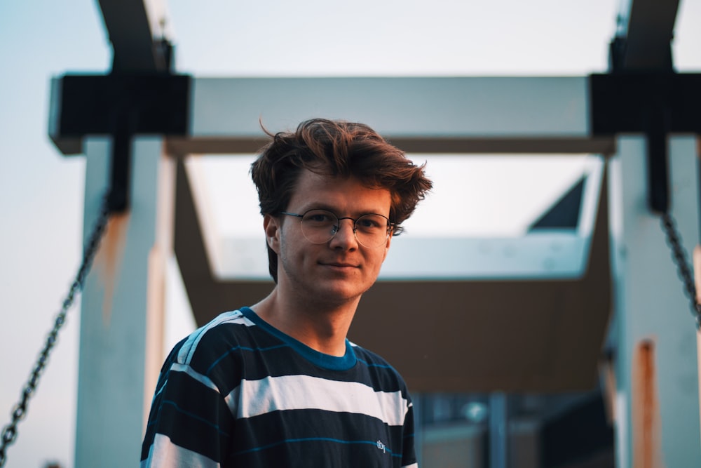 man in blue and white striped crew neck shirt wearing eyeglasses