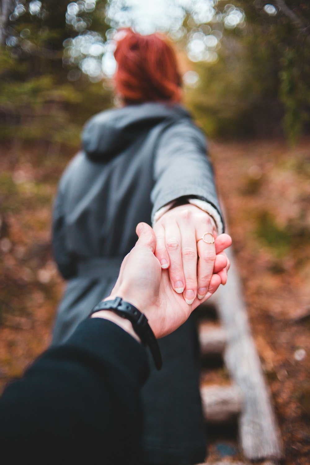 woman in black jacket holding her hand