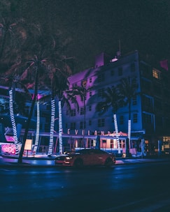cars on road near buildings during night time