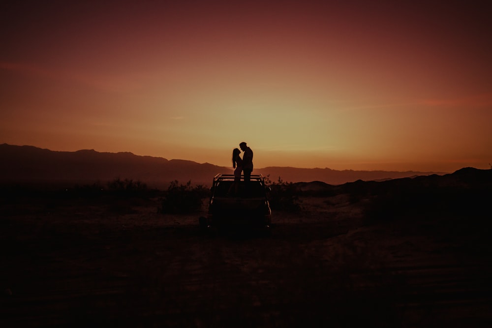 silhouette of man sitting on chair during sunset