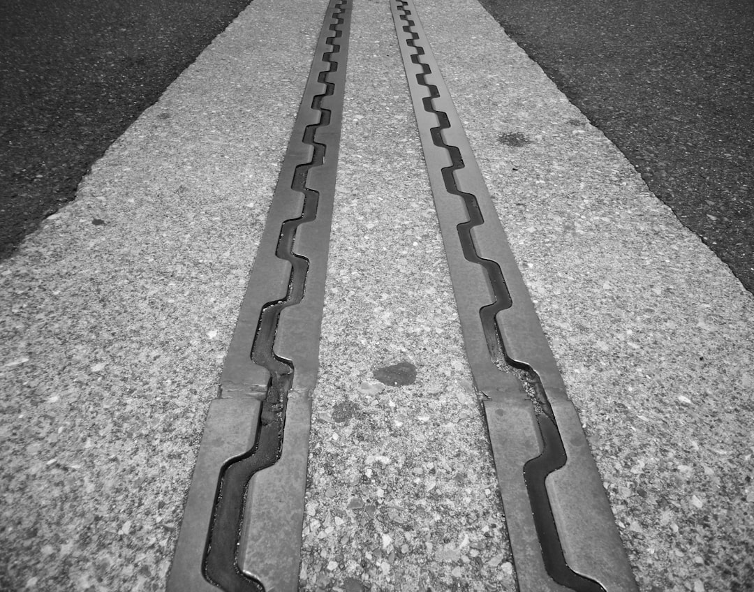 white arrow sign on gray concrete road