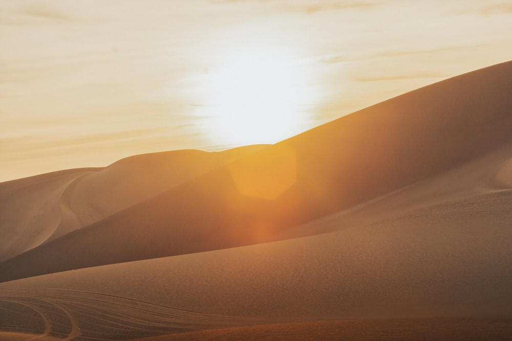 brown sand under white clouds during daytime