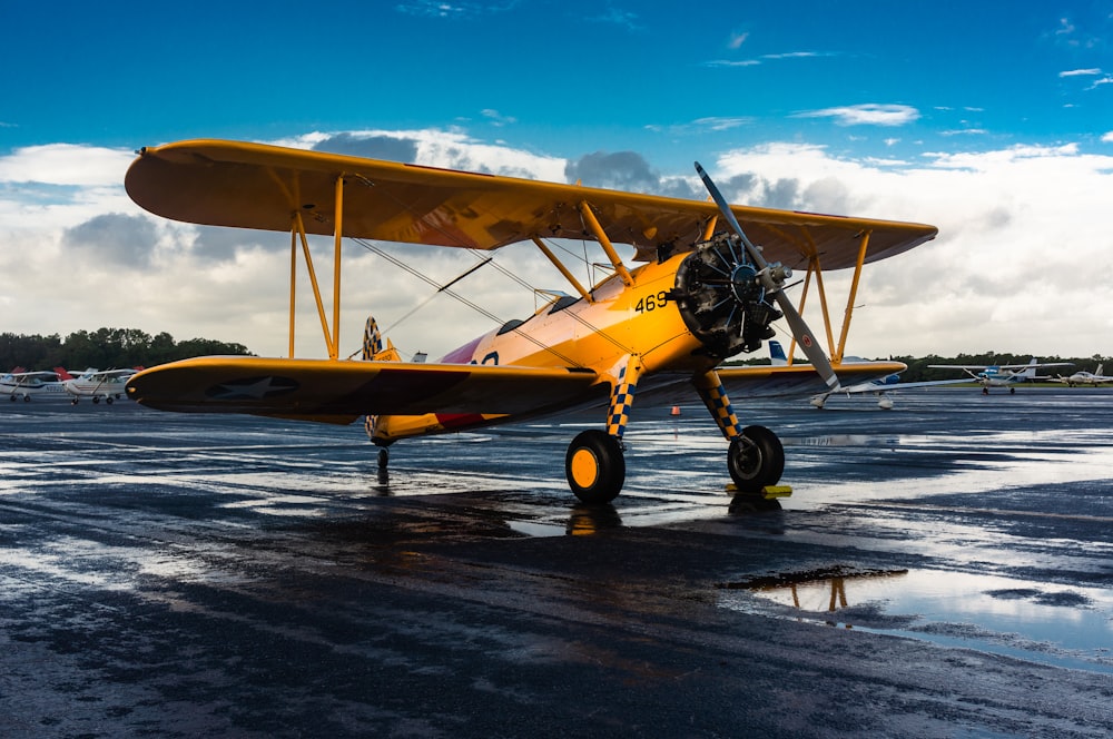 yellow and black plane on the road during daytime