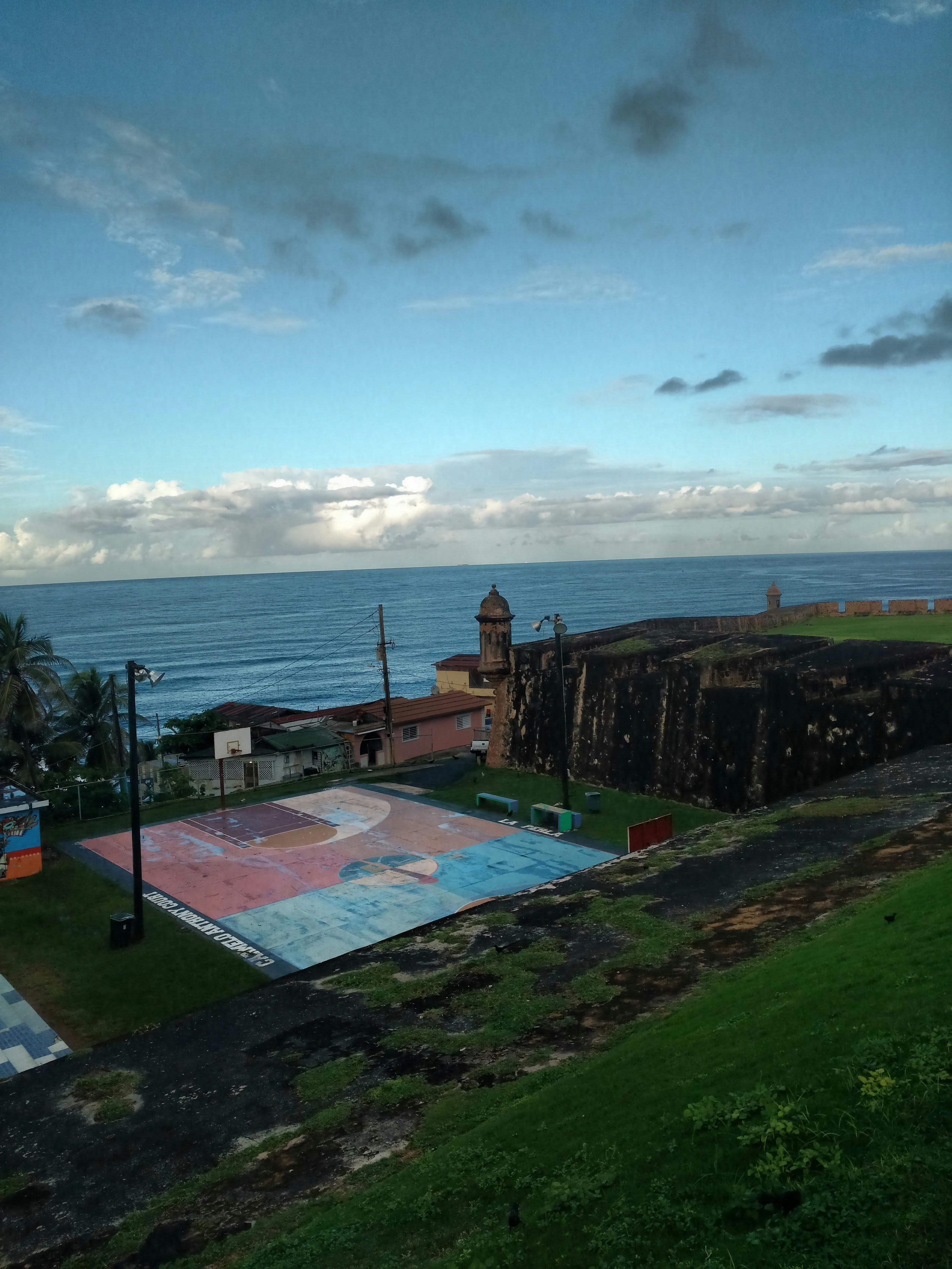 brown wooden house near body of water during daytime