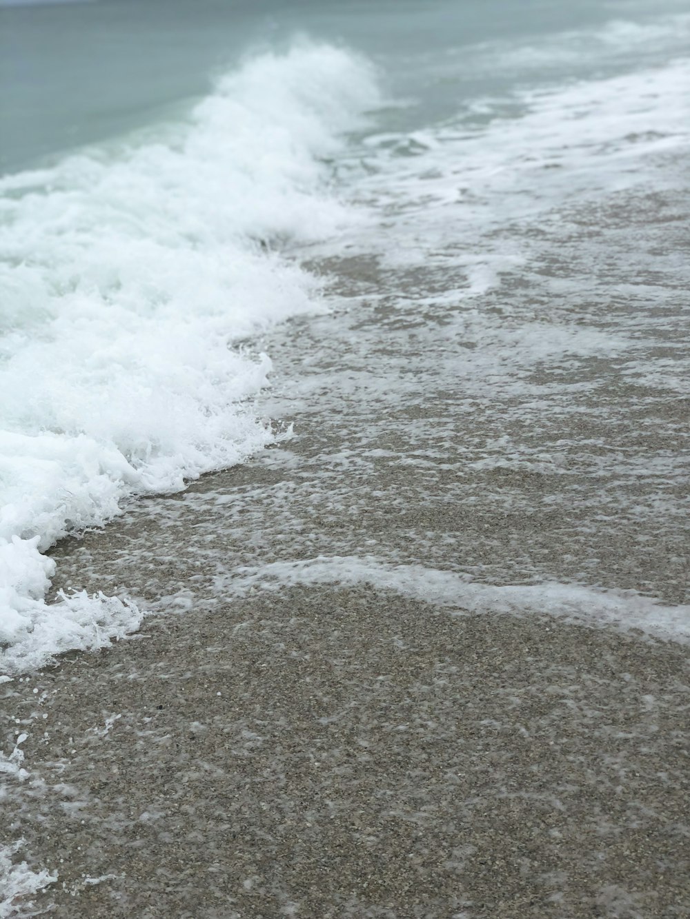 ocean waves crashing on shore during daytime