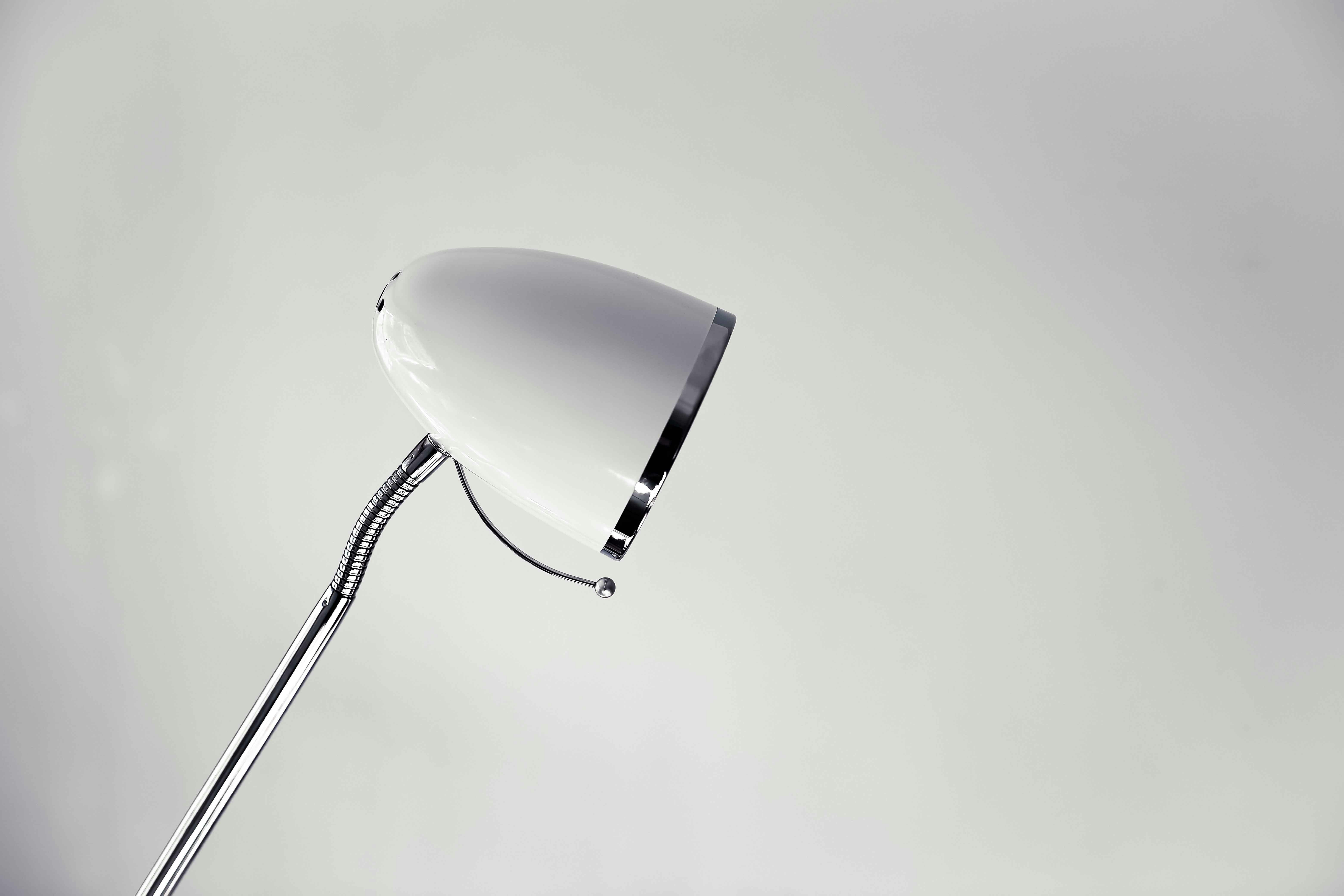 silver framed magnifying glass on white surface