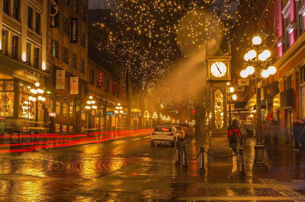 people walking on sidewalk near building during night time