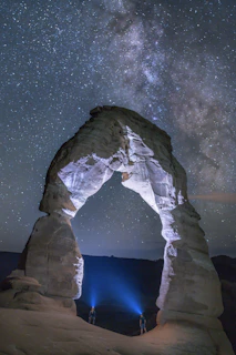gray rock formation under starry night