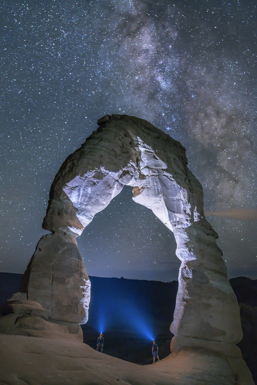 gray rock formation under starry night