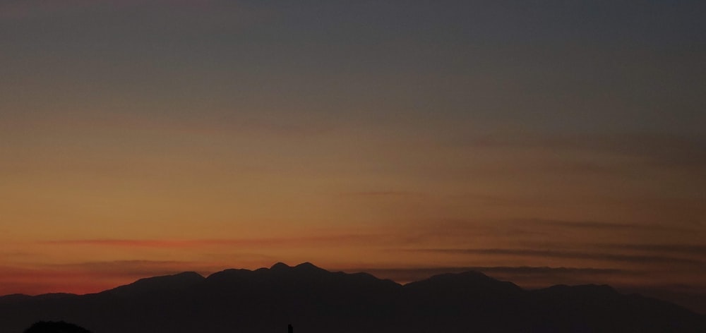 silhouette of mountains during sunset