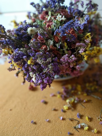 A vibrant arrangement of dried flowers in a soft, warm-toned setting.
