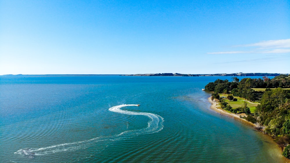 white boat on sea during daytime