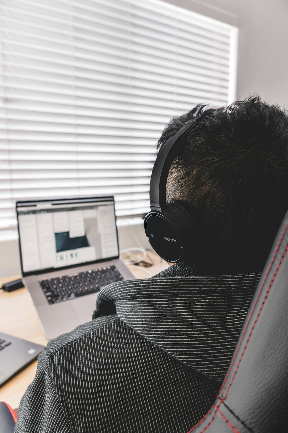 grayscale photo of person using laptop computer