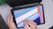 Close-up of hands designing a colorful Canva template on a tablet.