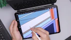 Close-up of hands customizing a t-shirt design on a digital tablet.
