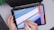 Close-up of a designer’s hands working on a digital tablet with vibrant graphics displayed.