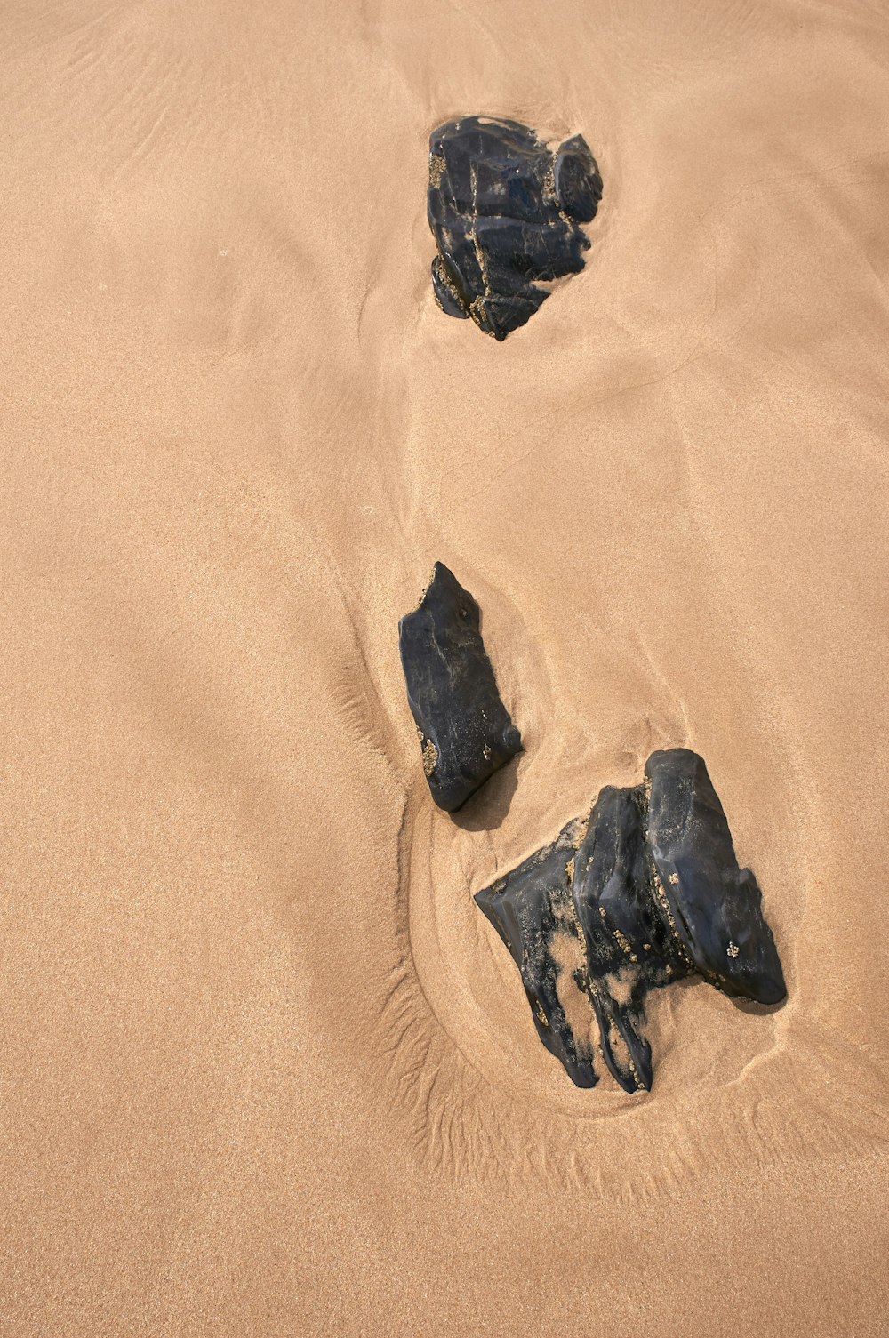 black stone on brown sand