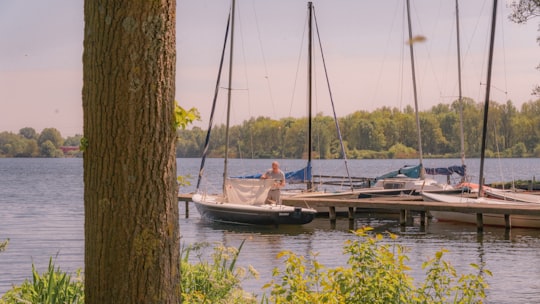 man and woman riding on boat during daytime in Gaasperplas Netherlands