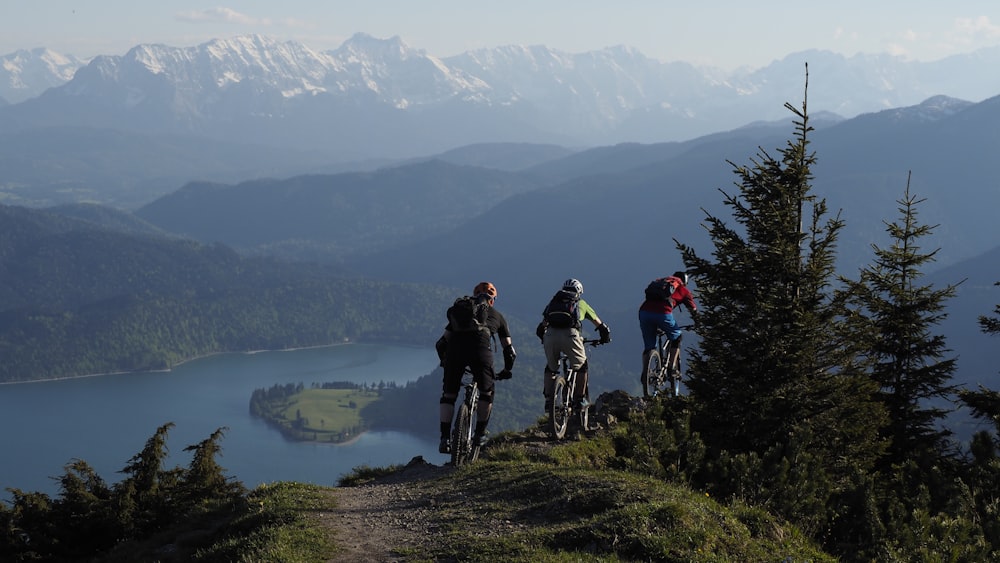three mountain bikers riding on a trail together