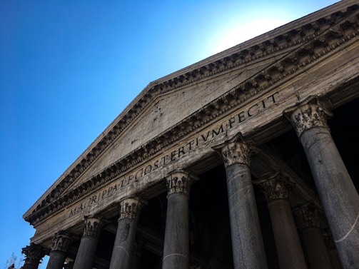 Transparent image of classical Greek columns as a background symbolizing justice and stability.