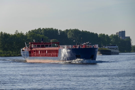 red and white boat on water during daytime in Ridderkerk Netherlands