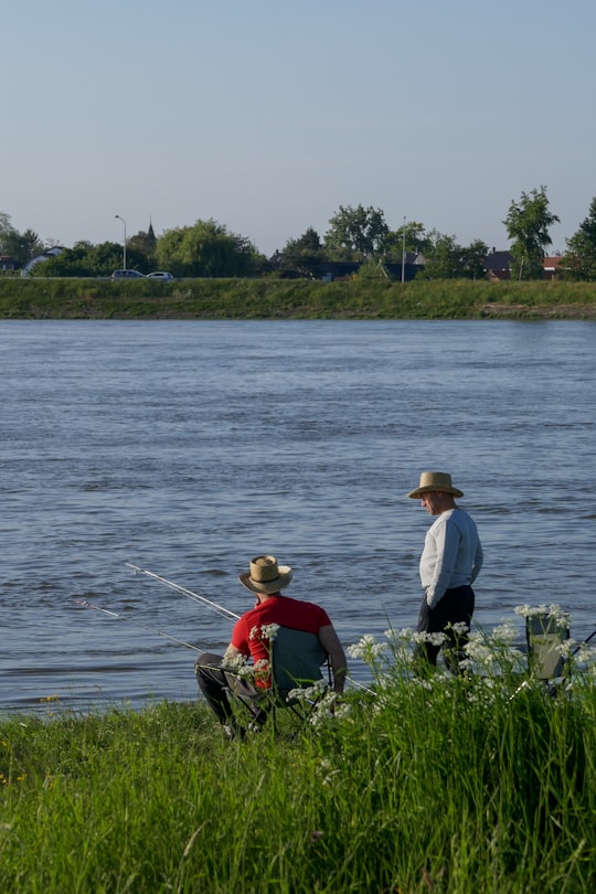 2 men fishing on lake during daytime in Ridderkerk Netherlands