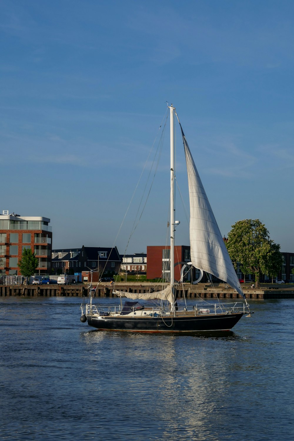 white sail boat on dock during daytime