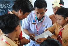 man in white button up shirt holding white smartphone