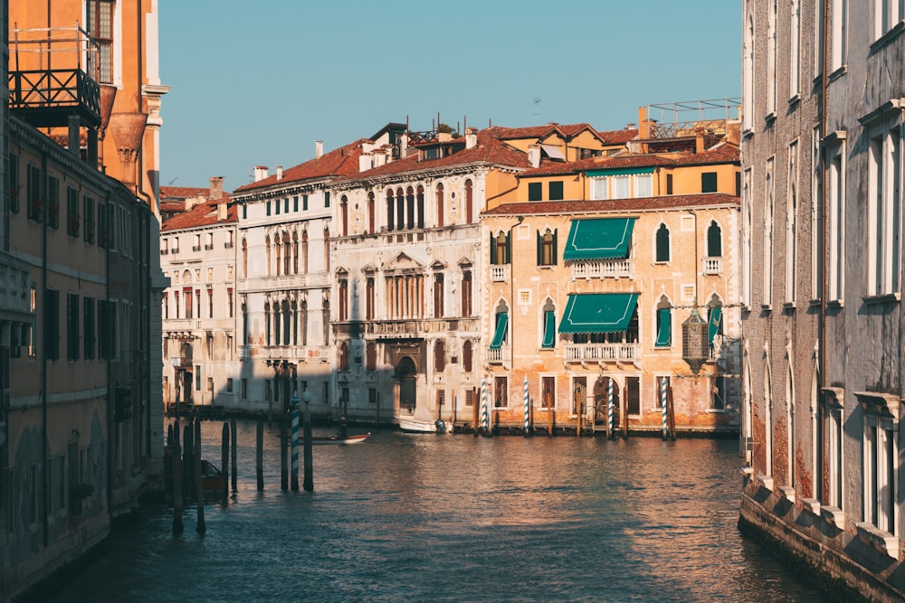 brown and white concrete building beside body of water during daytime