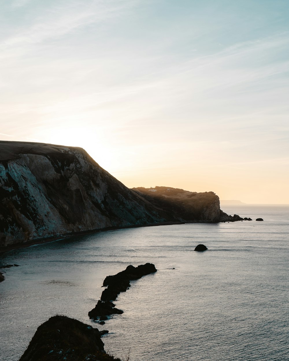 black rock formation on sea during daytime