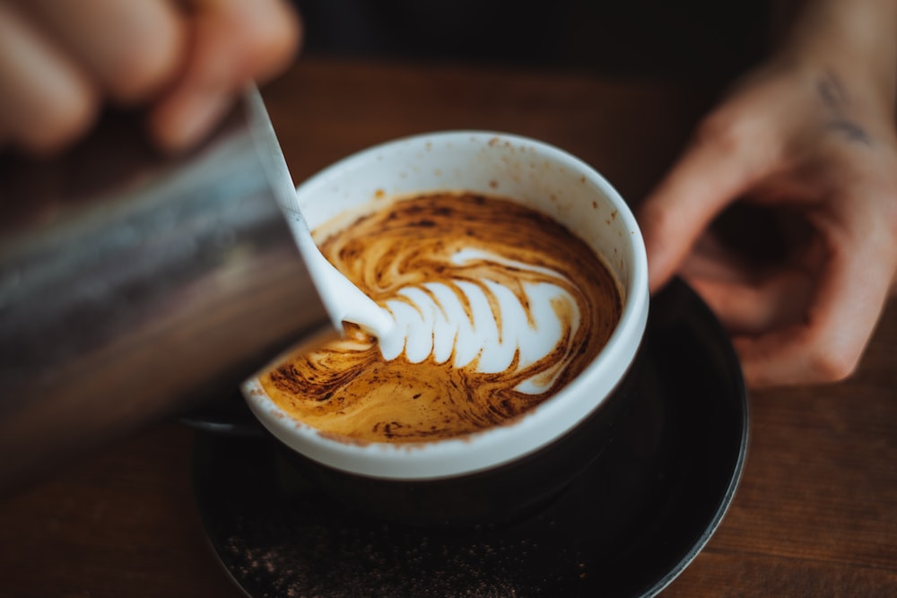 white ceramic cup with brown liquid