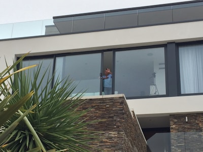 Dispatcher waving hello from a windowed office with natural light.