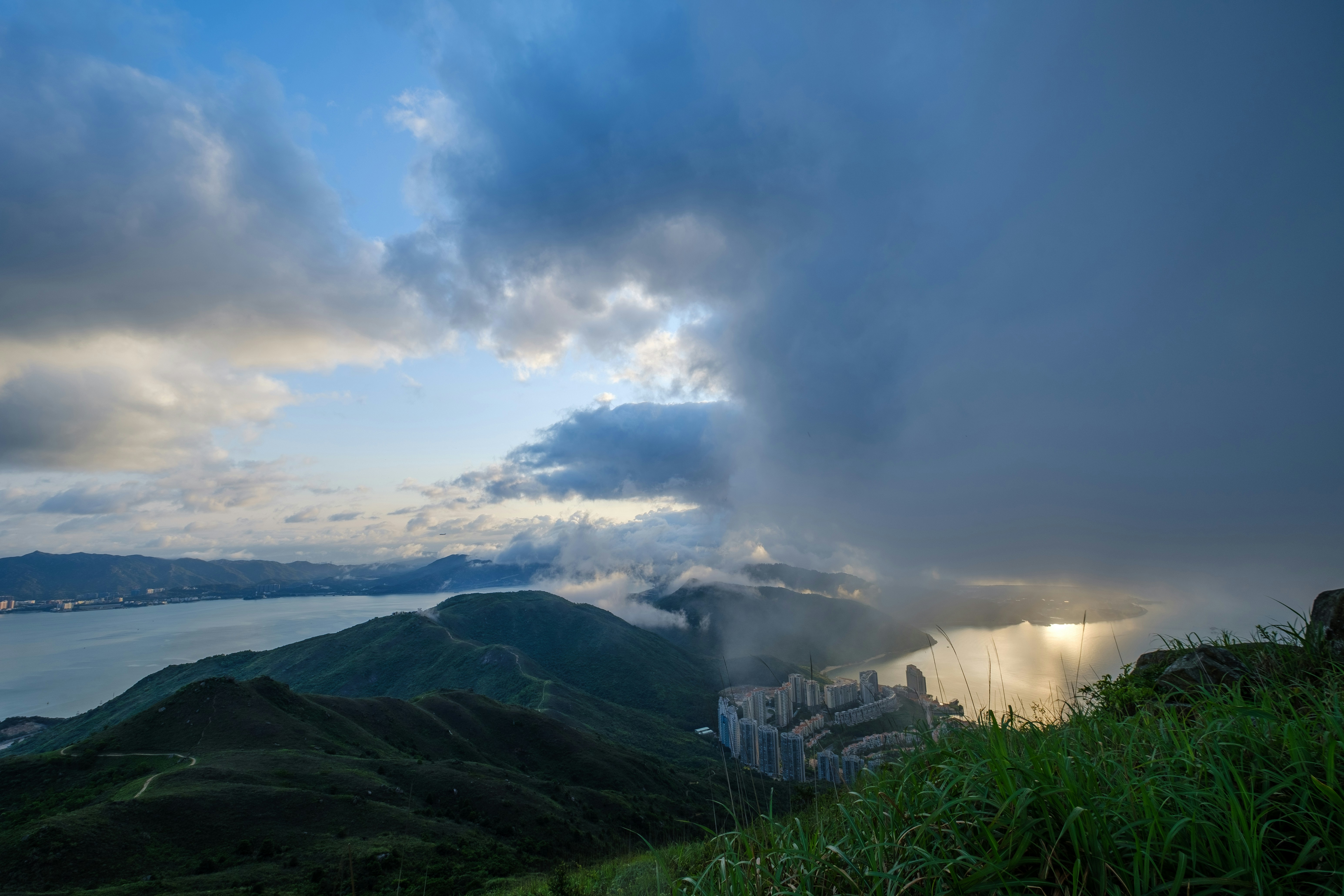 white and black house on green grass field under white clouds