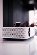 white and black portable speaker