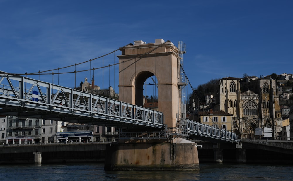 brown concrete bridge under blue sky during daytime