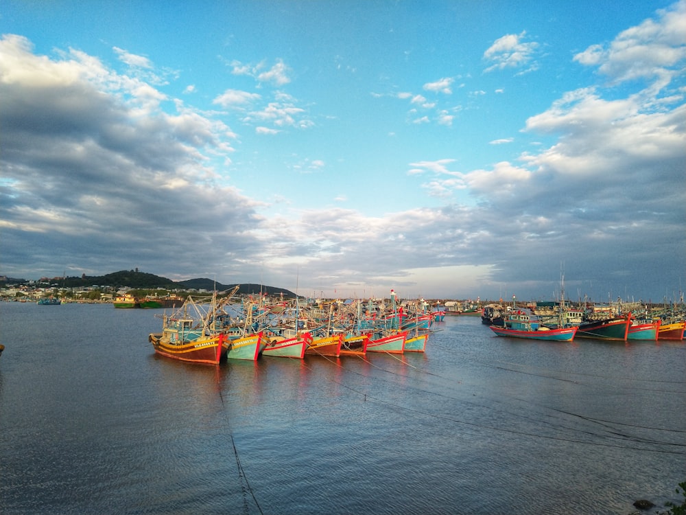 white and orange boat on sea under blue sky during daytime