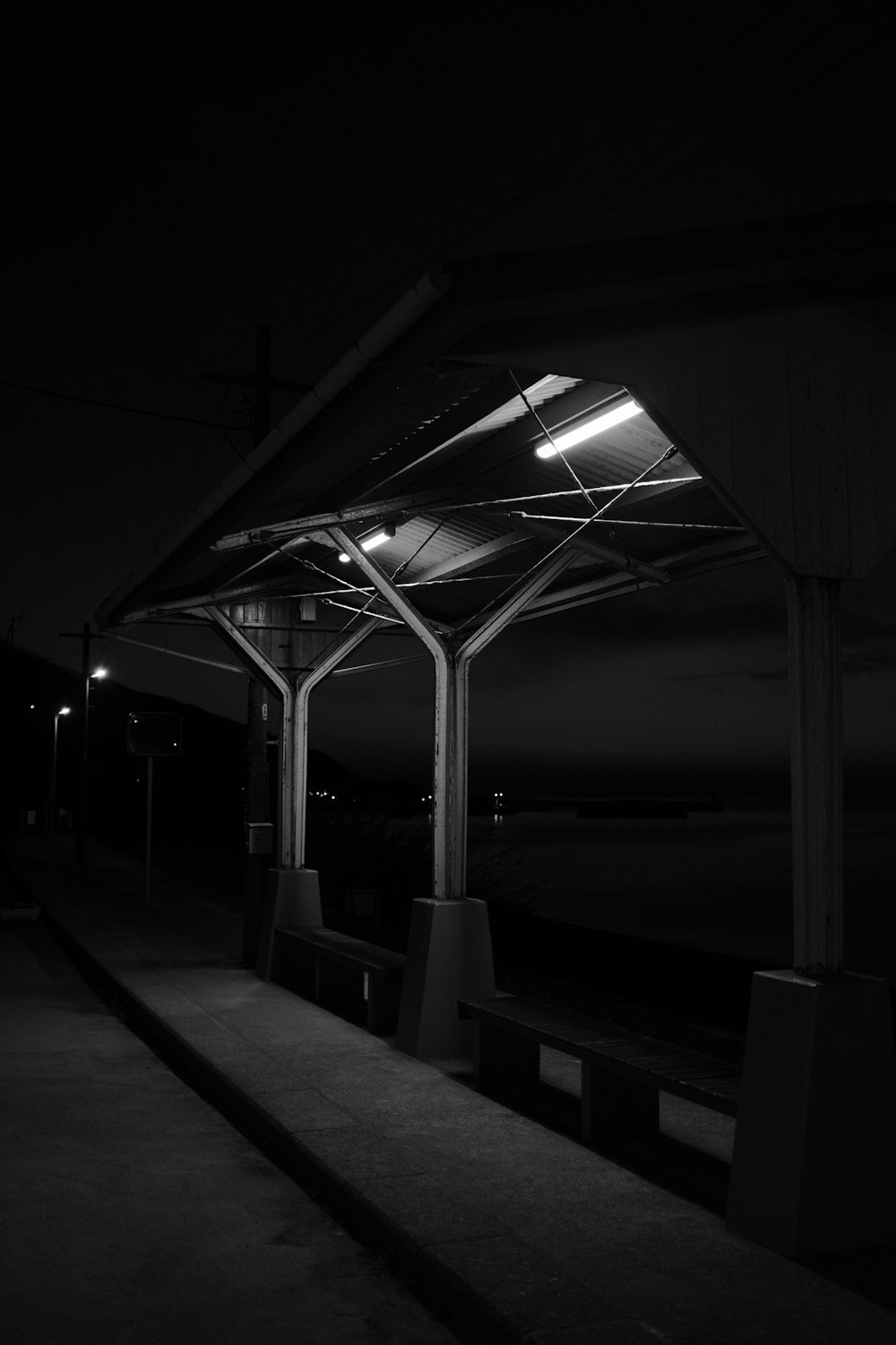 grayscale photo of a building near the sea