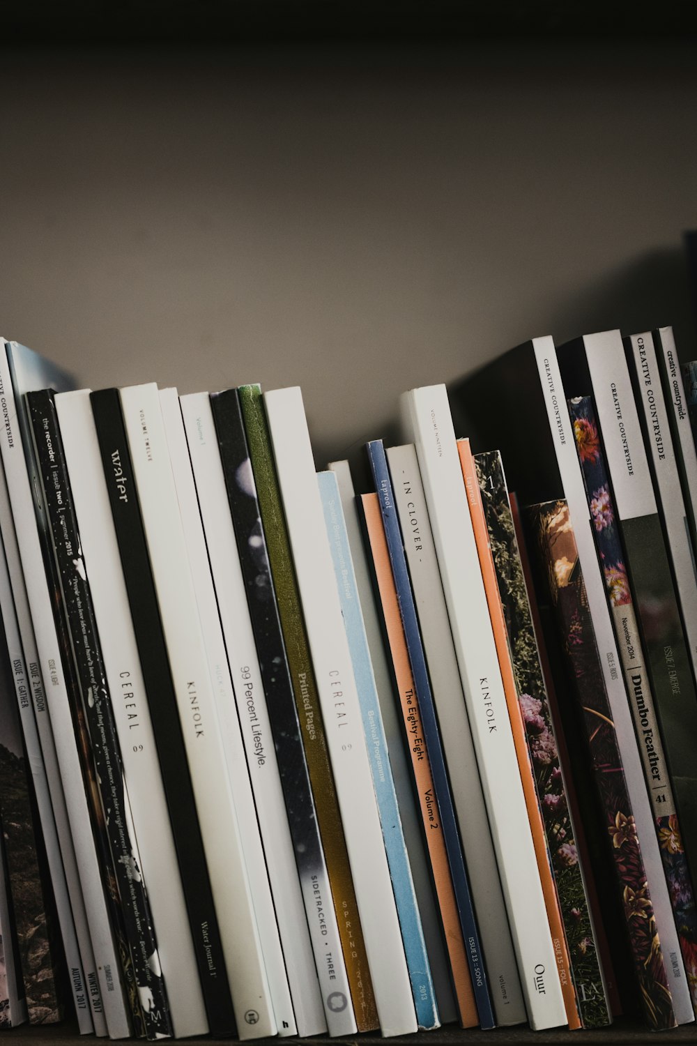 books on white wooden shelf