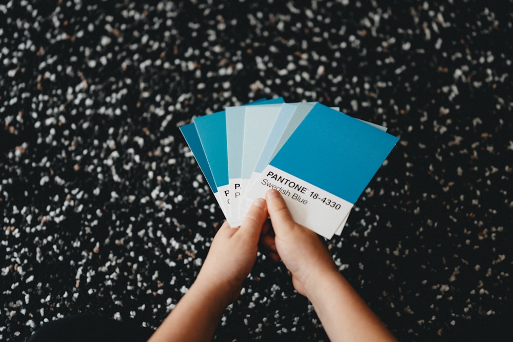 person holding blue and white box