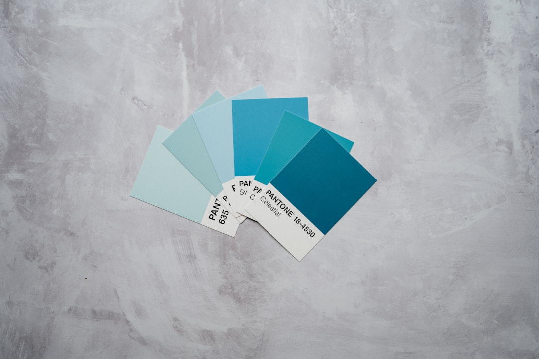 teal and white paper on gray concrete floor
