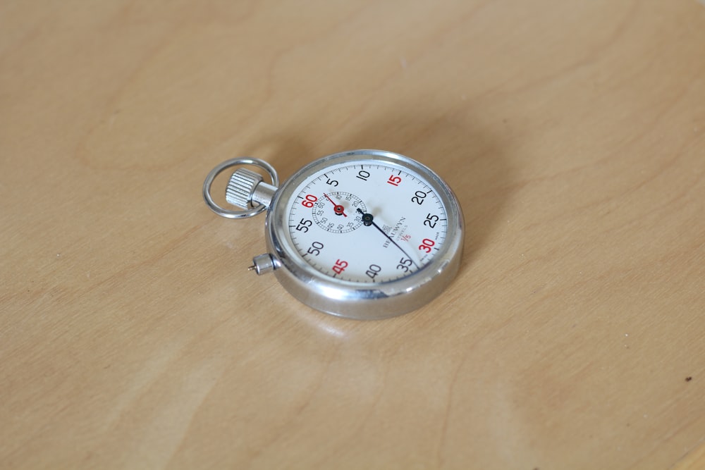 silver and white round analog watch