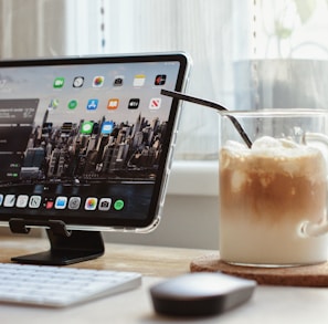 black ipad on brown wooden table