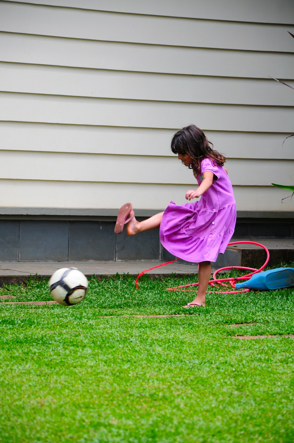 girl in pink dress playing soccer