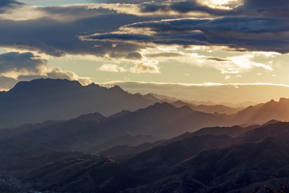 mountains under white clouds during daytime