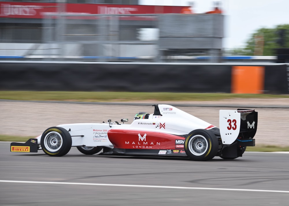 red and white f 1 car on road