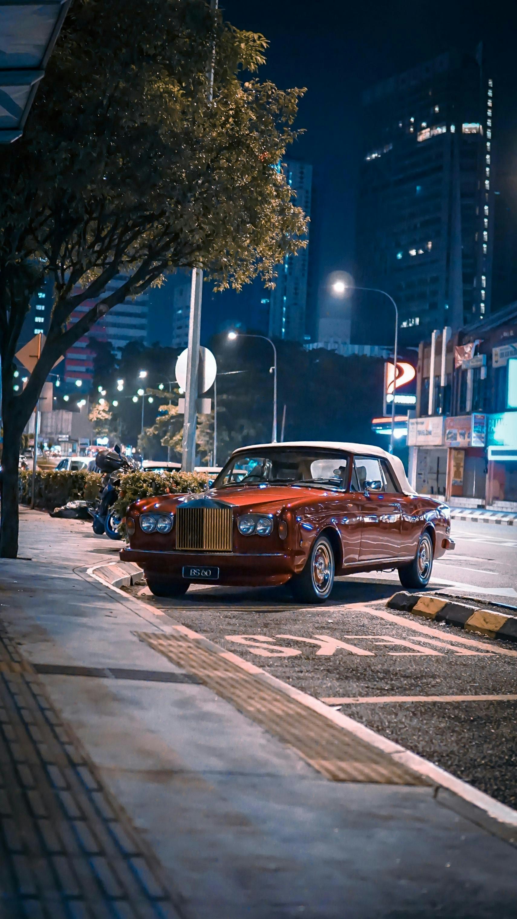 brown sedan on road during night time